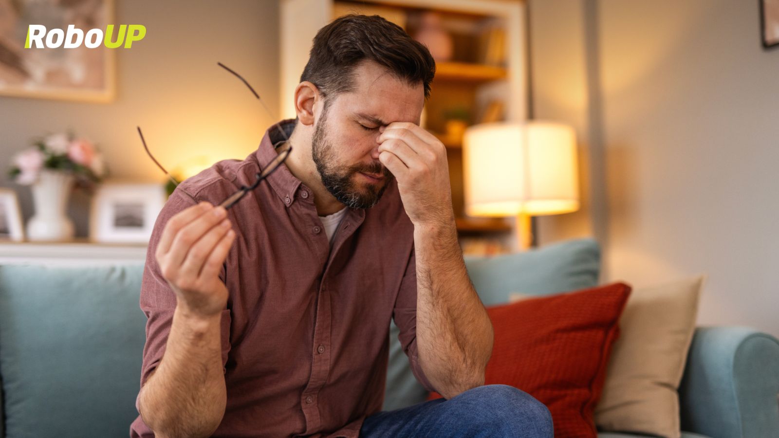 stressed-man-sitting-on-couch-holding.jpg